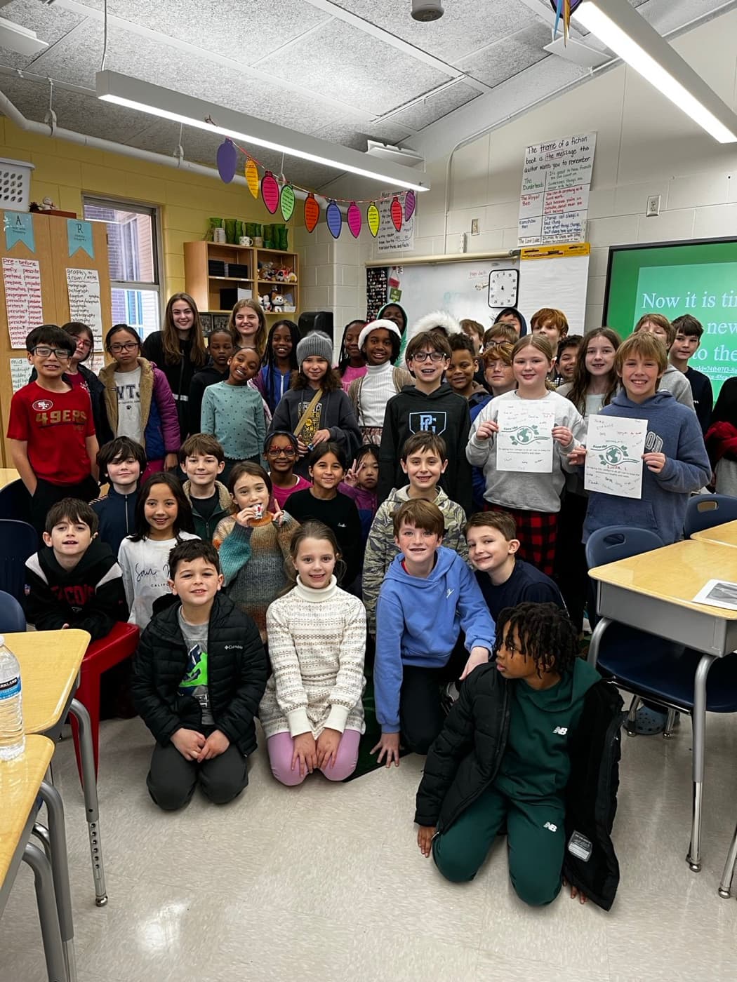 A mentor presenting a recycling lesson to a full classroom